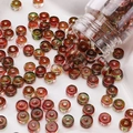 DIY colorful gradient 6x3mm round glass beads scattered on a white tray with bottle - 10g/Pack (Approx. 40 Pieces) / Reddish Brown