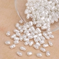 Creamy white irregular baroque ABS pearls in a glass bowl for DIY jewelry making - Small Rice Style (#35) / 5.5×3.5mm (50 Pieces/Pack) / Artificial Pearl White