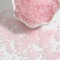 Pink iridescent glass seed beads for DIY jewelry making in a white ceramic bowl - Light Pink