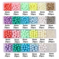 Detail view of colorful 4mm to 8mm acrylic pearls organized in a 24-grid plastic craft box - 24-Grid Boxed Multi-Color Beads