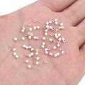 Silver-plated small square spacer beads held in palm to show miniature size for DIY jewelry - Square Faceted Style (FGT395) / 10 Pieces/Pack (2x2mm) / Silver