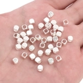 Hand holding silver plated cube spacer beads for DIY jewelry and bracelets making - Square Faceted Style (FGT395) / 10 Pieces/Pack (4x4mm) / Silver