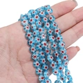 Flat round blue Millefiori glass bead with red floral pattern for DIY jewelry making - Blue