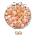 Pink and champagne gradient cat-eye resin beads on a vintage silver display tray - Orange Pink