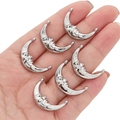 Set of six silver crescent moon face charms for DIY jewelry making held in palm - Moon Face Pendant / 1 Piece