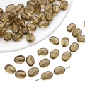 Detailed view of coffee bean shaped acrylic beads with gold S-line and needle threading - 30 Pieces/Pack (11x8mm) / Transparent Grey Gold Traced