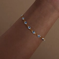 Golden titanium steel bracelet featuring colorful enamel evil eye charms on wrist - Bracelet / White Blue Style (E459)