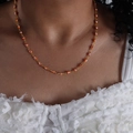 Gold-plated titanium chain bracelet with orange and white evil eye charms on wrist - Orange Style (P1528)