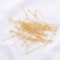 Close-up of golden eye pins for jewelry making stacked on white fabric texture - 0.7x20mm (50 Pieces/Pack) / 18K Gold Plated