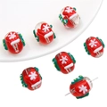 Detailed view of red Christmas snowman beads with snowflake patterns for DIY jewelry making - Gloves