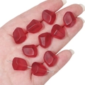 Close-up of frosted red faceted glass beads shaped like pomegranate seeds for jewelry DIY - Red