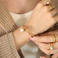 Elegant gold titanium steel bracelet with pearl pendant and matching rings for women - Gold
