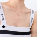 Elegant rose gold star and moon pendant necklace shown on a model's collarbone - Rose Gold Star Moon Necklace (P315) / 48cm