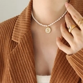 Elegant freshwater pearl necklace with gold-framed enamel pendant featuring capital letter S - Letter S