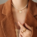 Freshwater pearl necklace with gold letter C shell pendant shown on a model - Letter C