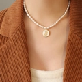 French style pearl necklace with gold letter B pendant on a white shell base - Letter B