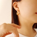 Minimalist 18k gold plated titanium heart earrings with white pearl inlay on model - Gold