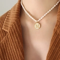 Elegant gold-trimmed freshwater pearl necklace featuring a white shell 'M' letter pendant - Letter M