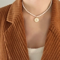 French style pearl necklace featuring a gold-rimmed white shell letter K pendant - Letter K