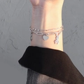 Double-layered silver bracelet with bunny and heart charms worn on a female wrist - Silver