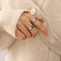 Elegant silver ring with a square green zircon stone worn in a minimalist fashion style - US 7 / Steel