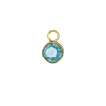 Macro shot of light blue round faceted birthstone pendant with gold bezel setting - March / Gold