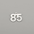 Detailed macro view of polished number 85 stainless steel pendant with hanging loop - Number 85 / Steel