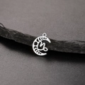Macro shot of silver stainless steel crescent moon pendant with Capricorn zodiac cutout - Silver-Capricorn