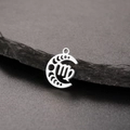 Detailed view of silver stainless steel Virgo zodiac moon phase pendant on dark rock - Silver-Virgo
