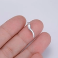Macro shot showing small silver stainless steel chili pendant held by fingers - Single Pendant (Steel Color) / Steel