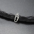 Mini stainless steel flip flop pendant with cutout design on a natural stone base - Steel