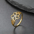 Golden flower ring with hollow petals and central zircon on a textured stone background - US 7 / Gold