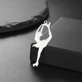 Polished silver skater pendant on a dark jewelry box with mirror finish detail - Spin Pose (Style 3-Steel)