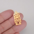 Macro view of a 18K gold plated hollow Joker mask pendant with detailed tribal engraving - Style 3 Gold