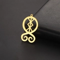 Detailed close-up of a golden troll cross pendant with intricate rune-inspired design - Gold