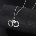 Hip hop silver handcuffs pendant necklace with delicate chain on dark background - Antique Silver