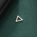 Macro view of geometric hollow triangle pendant with polished silver finish - Style 9-Steel Color