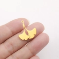 Close-up of golden ginkgo leaf charm showing size held by hand for DIY jewelry making - Gingko Leaf Shape - Gold