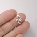 Macro shot of a tiny hollowed-out cactus pendant charm in stainless steel for DIY jewelry - Cactus Hollow - Steel Color