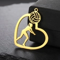 Macro view of gold-plated heart pendant featuring a volleyball player silhouette design - Gold