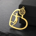 Detailed close-up of a gold-plated heart-shaped volleyball pendant on a stone base - Gold