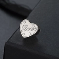 Macro detail of silver heart charm with Love engraving and side hole for DIY jewelry - Love Style (SS2024052227-34) / Love-Silver