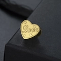 Macro shot of a golden heart charm with Love embossing for DIY jewelry bracelets - Love Style (SS2024052227-34) / LOVE - Gold