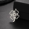 Macro shot of silver stainless steel four-leaf clover pendant with hollow heart design - Steel