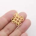 18K gold plated stainless steel Celtic knot clover pendant held between two fingers - Celtic Knot Clover - Gold