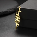 Detailed macro shot of a golden Ogham symbol pendant on a minimalist black gift box - LOVE Style / Gold