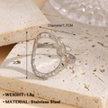 Irregular hammered silver stainless steel open ring shown on a stone display tray - Steel Oval Hammered Style (1029)