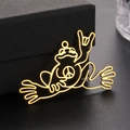18K gold-plated stainless steel peace frog pendant on a textured black jewelry box - Gold