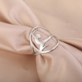 Hollow out gymnast silhouette ring in silver stainless steel on champagne satin fabric - US 6 / Steel