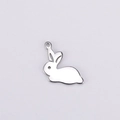 Detailed view of mirror polished stainless steel rabbit pendant with hollow eye detail - Steel